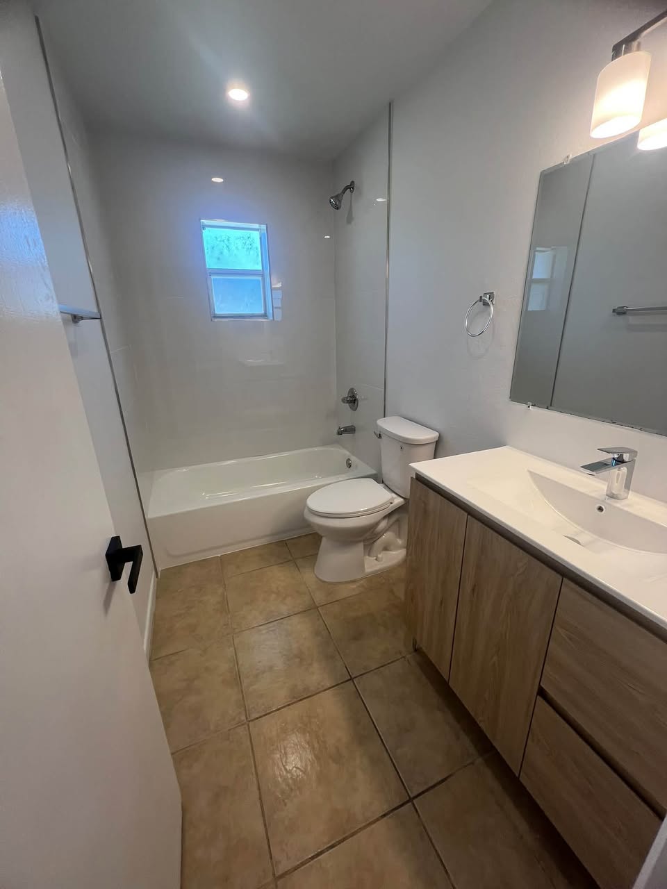 Freshly cleaned bathroom: tub, toilet and vanity